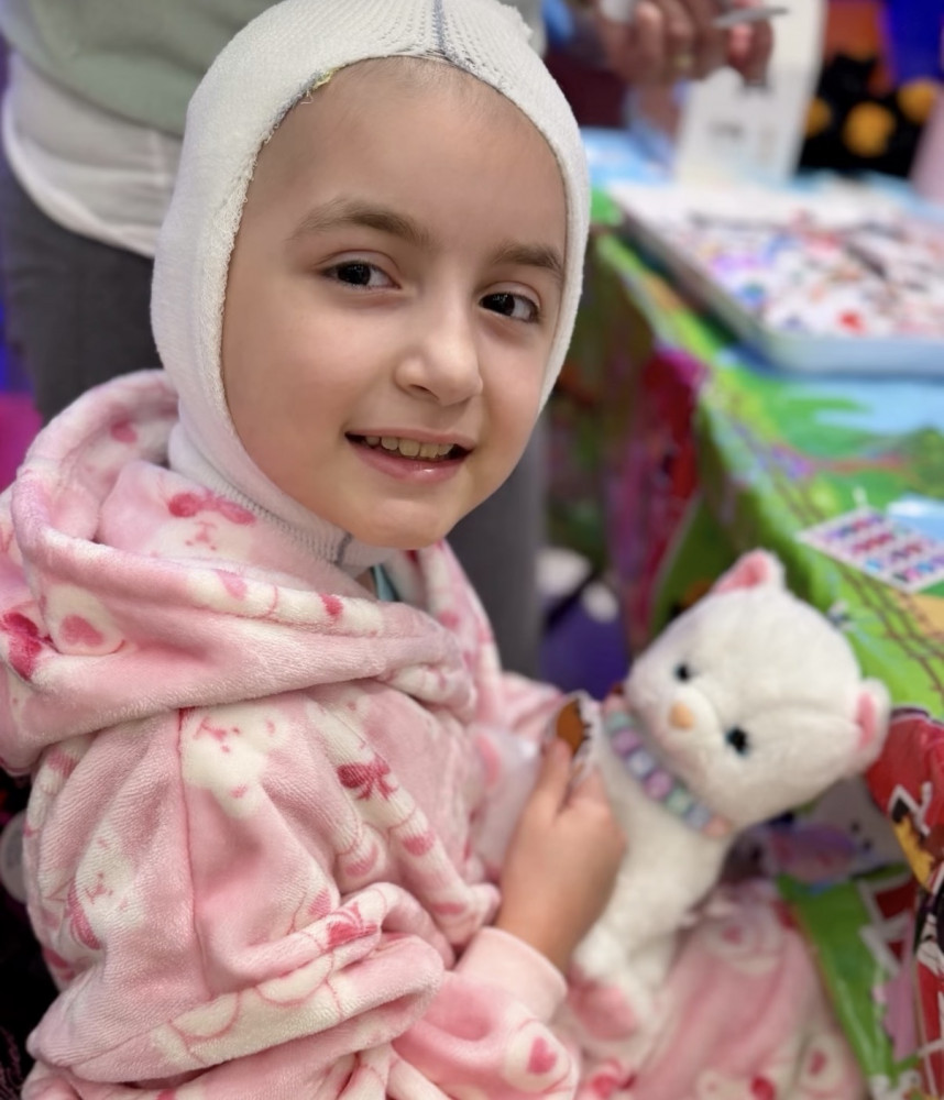 Hero Abby Castro Sobrino smiling in a Gamerosity superhero cape